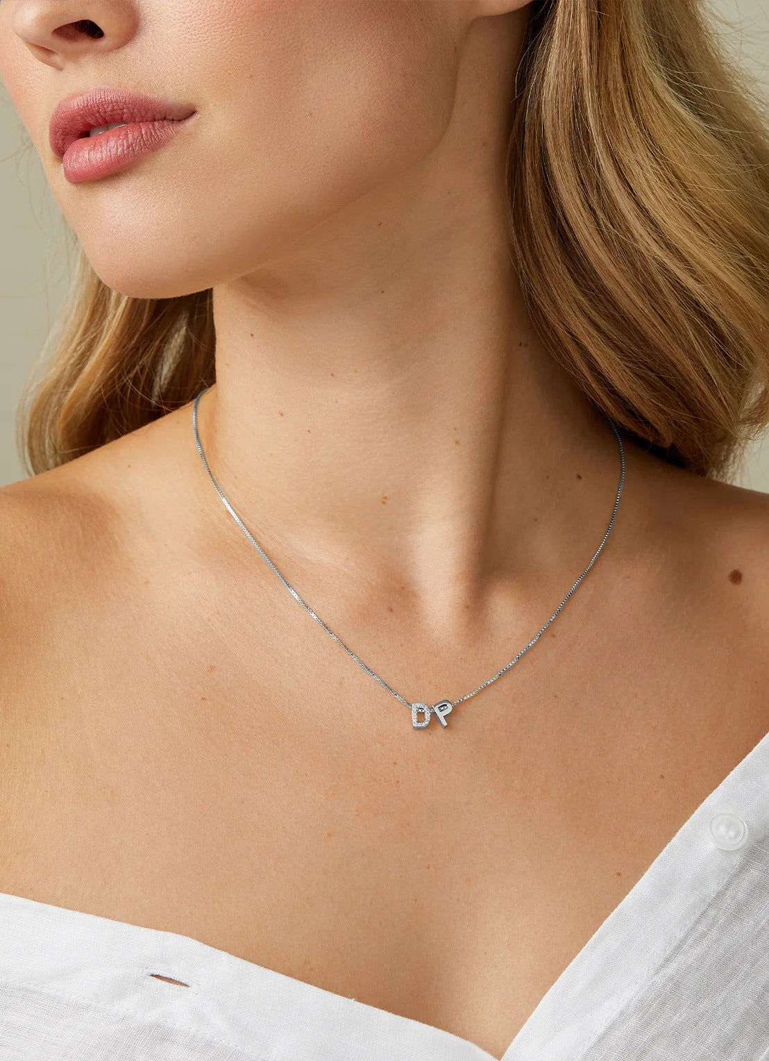 Exquisite ketting met op maat gemaakte letters en bedels, die de schoonheid van individuele verhalen vastlegt die met elkaar verweven zijn.
