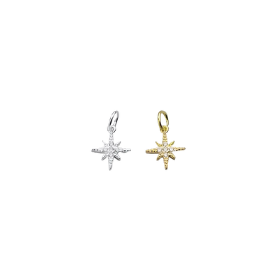 Een gouden ochtendster-bedeltje, versierd met sprankelende zirconia, die het eerste licht van de dageraad in delicate elegantie vangt